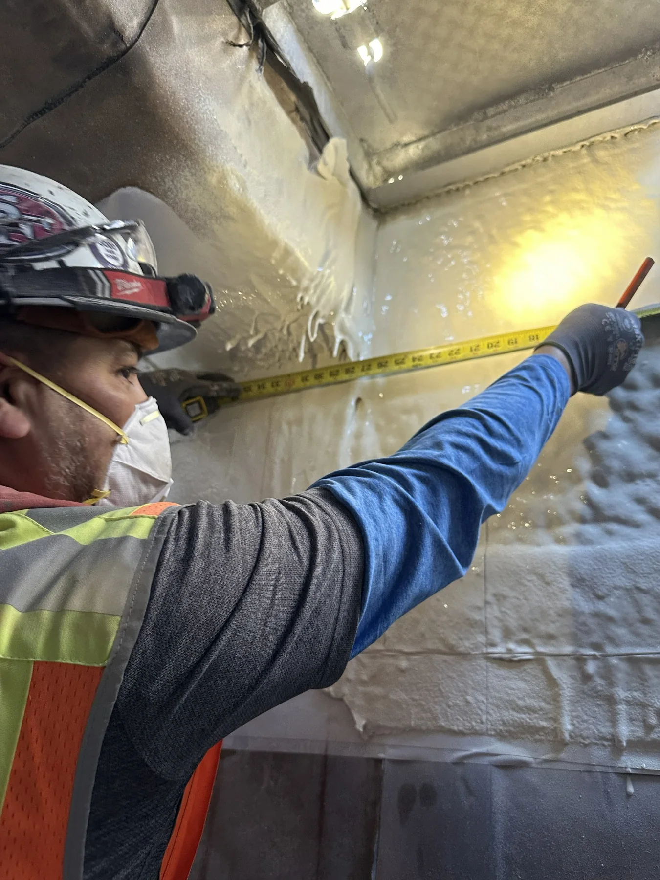 Construction professional measuring carefully during interior work